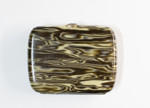 Closed Bakelite veneer cigarette case.
