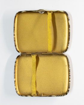 Opened Bakelite veneer cigarette case.