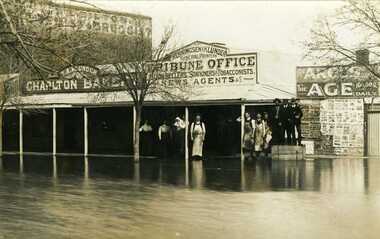 Photograph - 1909 Flood - High Street Charlton, 1909 Flood - High Street Charlton - Group of men & women standing in front of Tribune Office - Men on right standing on boxes with some men wearing white aprons