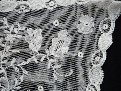 detail of lace collar on black background