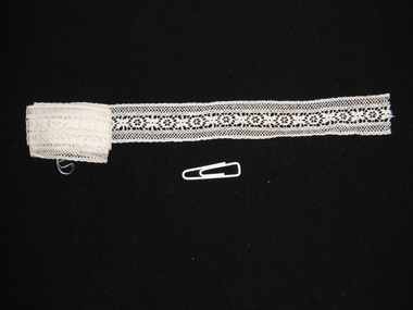 photograph of lace trim on black background