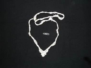 lace piece against black background
