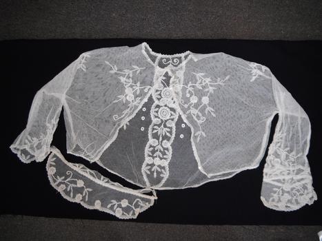 a small lace bed jacket