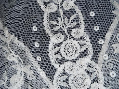 detail of a small lace bed jacket