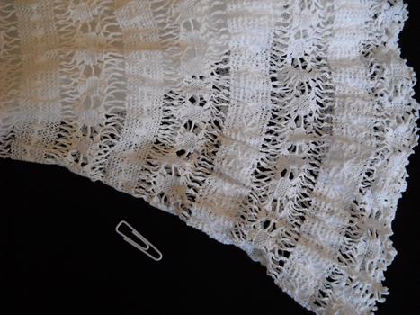 detail of white petticoat on black ground