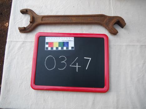 rusted spanner on white sheet