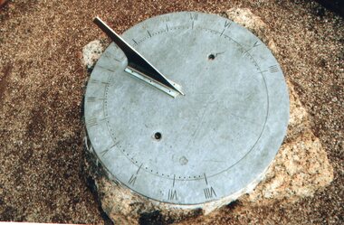 Sundial on granite pillar