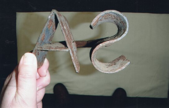 Metal branding owning showing initials AS. This is the reverse of SA as the branding iron belonged to Samuel Amess