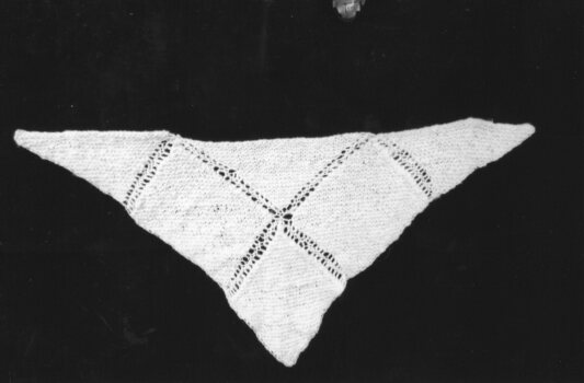 a white knitted woolen shawl