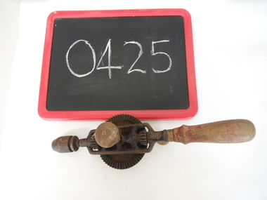 hand drill and blackboard on white sheet