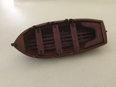 Wooden model of Lady Nelson ship tender. It is life boat with three bench seats and stern seating. 