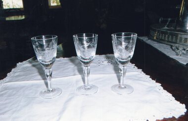 multiple small liqueur glasses on tablecloth