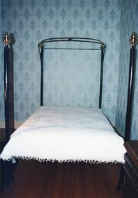 black cast iron four poster bed with castors