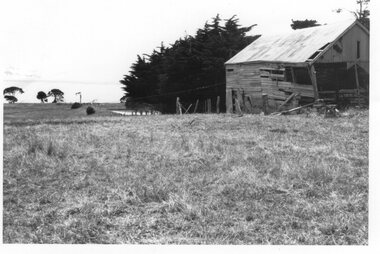 Photograph of a barn and a paddock