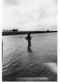 Photograph of a man wading in water, c.1940s
