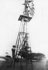 Photograph - Black and white photograph of people painting a windmill, c.1940