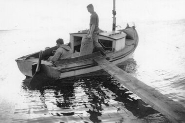 Photograph - Black and white photograph of two people in a small boat, c.1940