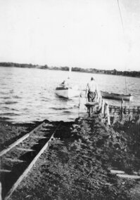 Photograph - Black and white photograph of a man and a boat, c.1940