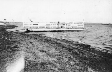 Photograph - Black and white photograph of a ferry docked on the shoreline, c.1941