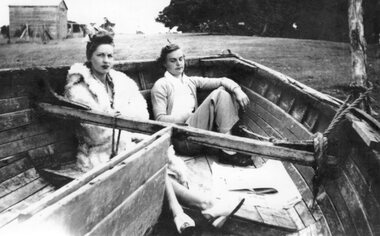 Photograph - Black and white photograph of two people sitting in a boat, c.1940