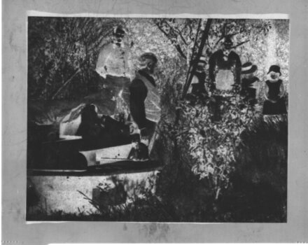 Negative of family standing near the cannon