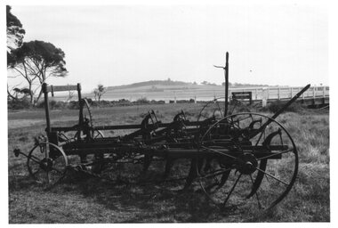 Photograph of farm machinery in front of shoreline