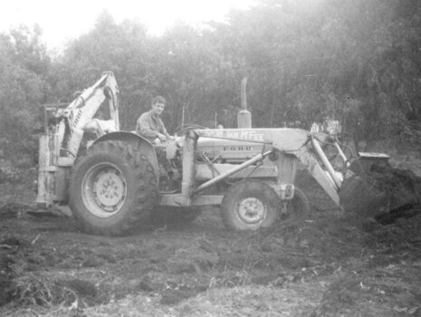 Photograph of a man on a Ford escavator