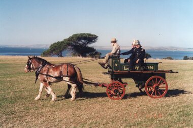 Photograph of people on cart
