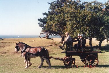 Photograph of people on cart