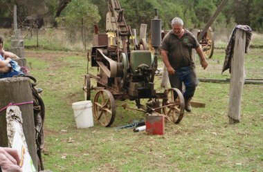 Photograph of farm machinery and man