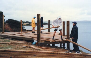 Photograph of people building a jetty