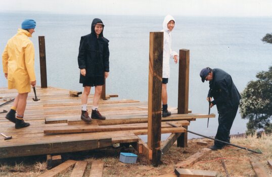 Photograph of people building a jetty