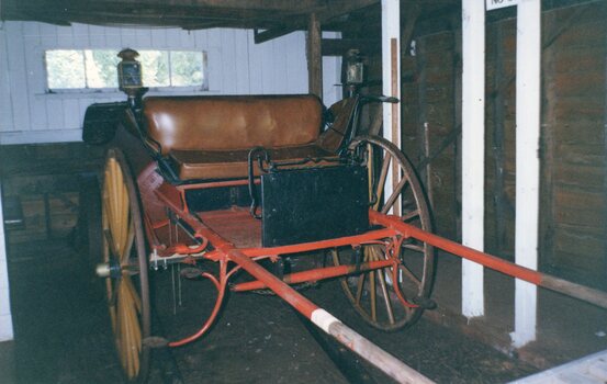 Photograph of a buggy parked in the Barn