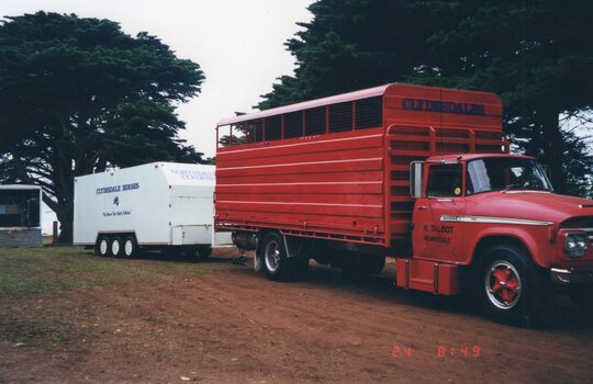 Photograph of red horse transport truck and trailer