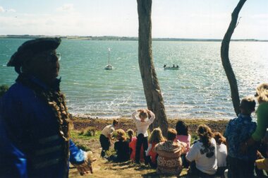 Photograph of seated group beside the shoreline