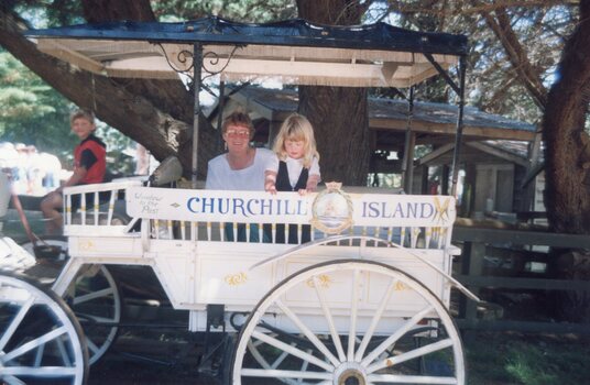 Photograph of two people in wagon