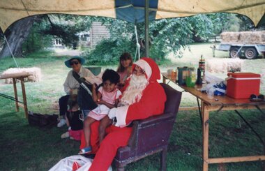 Photograph of child sitting on Santa's lap