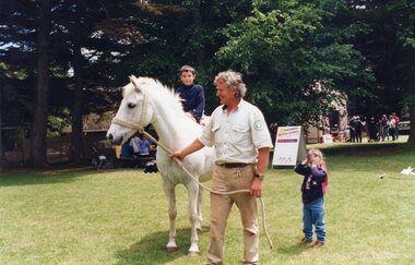 Photograph of a child on a horse