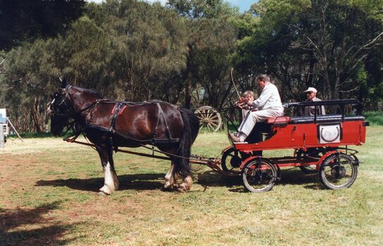 Photograph of red cart and horse