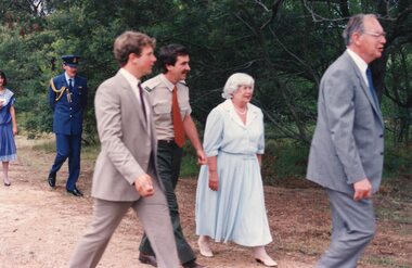 Photograph of four people walking