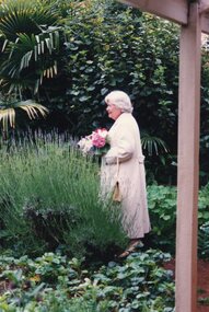Photograph of a woman standing in the garden