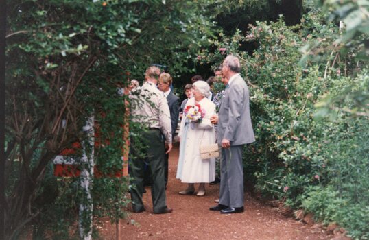 Photograph of group standing on a garden path