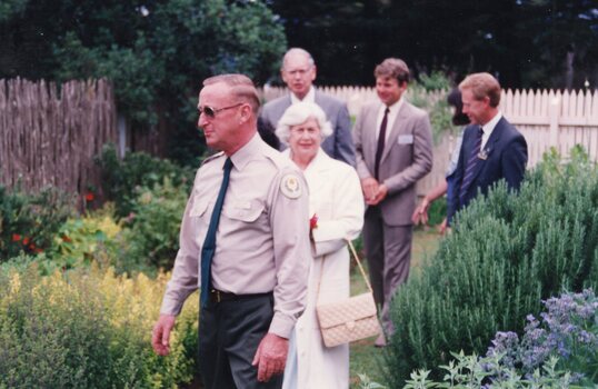 Photograph of group walking through garden