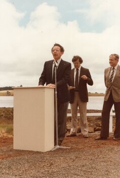 Photograph of man talking at a podium