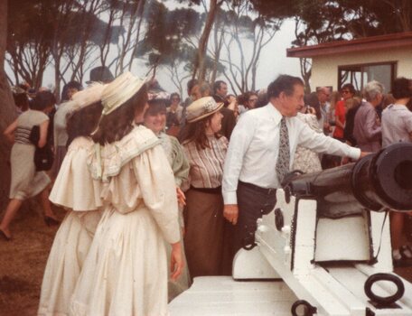 Photograph of group standing around the cannon