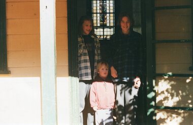 Photograph of people standing in the doorway