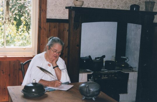 Photograph of a woman writing
