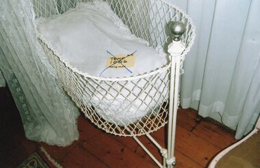 a steel mesh child's cradle