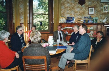 Photograph of group seated around table
