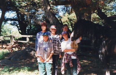 Photograph of five children and a horse